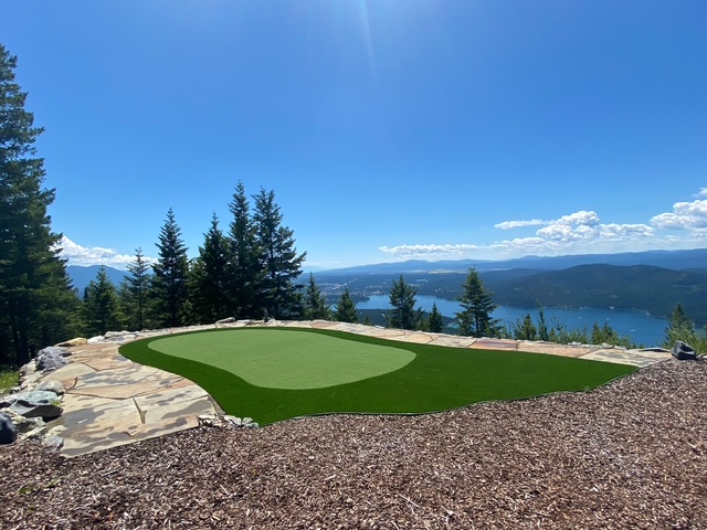An artificial grass putting green overlooking the lake and mountains installed by Mountain Turf Pros!