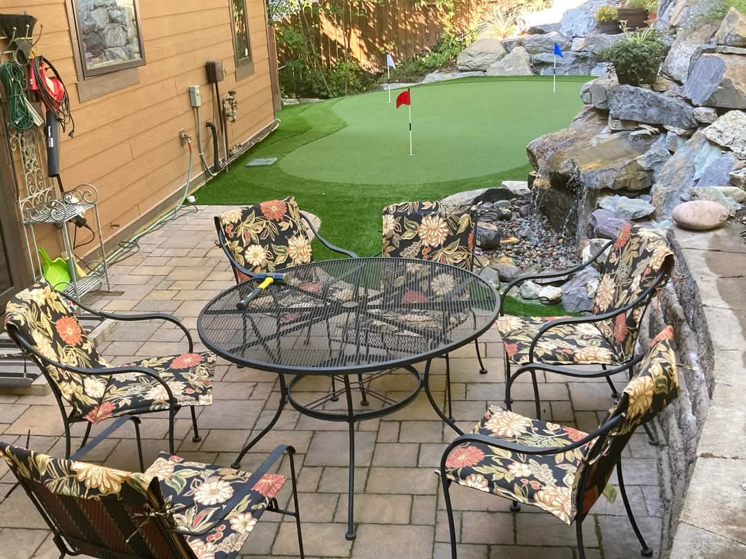 Patio and landscaped putting green and backyard artificial grass field turf installion by Mountain Turf pros