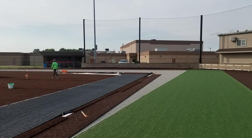 Mountain Turf Pro crew installing an artificial grass football field in the early phase of the project.