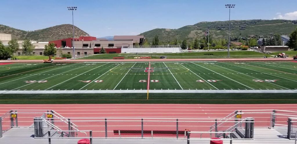 A wide view of a finished artificial grass football field