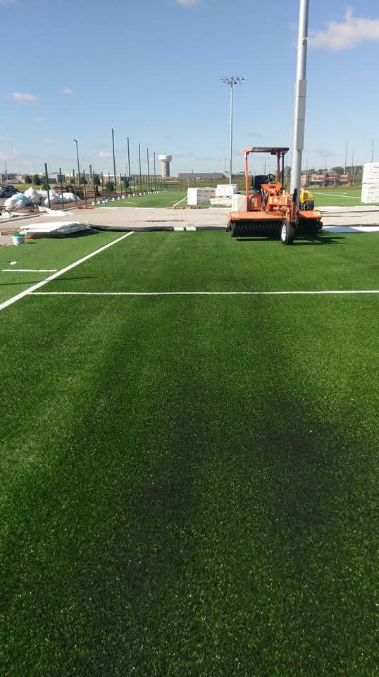 Brushing machine used to as part of the finishing touches of an artificial grass football field